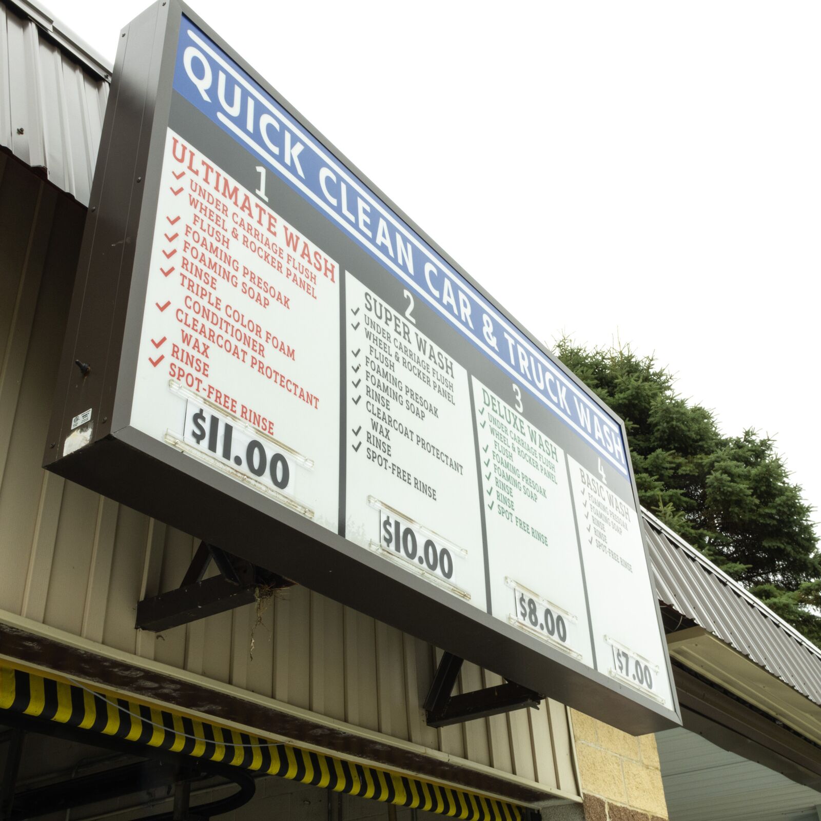 Wash package pricing sign at Quick Clean Car and Truck Wash