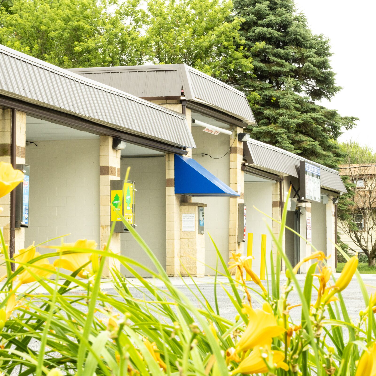 Landscaped entrance to Quick Clean Car and Truck Wash