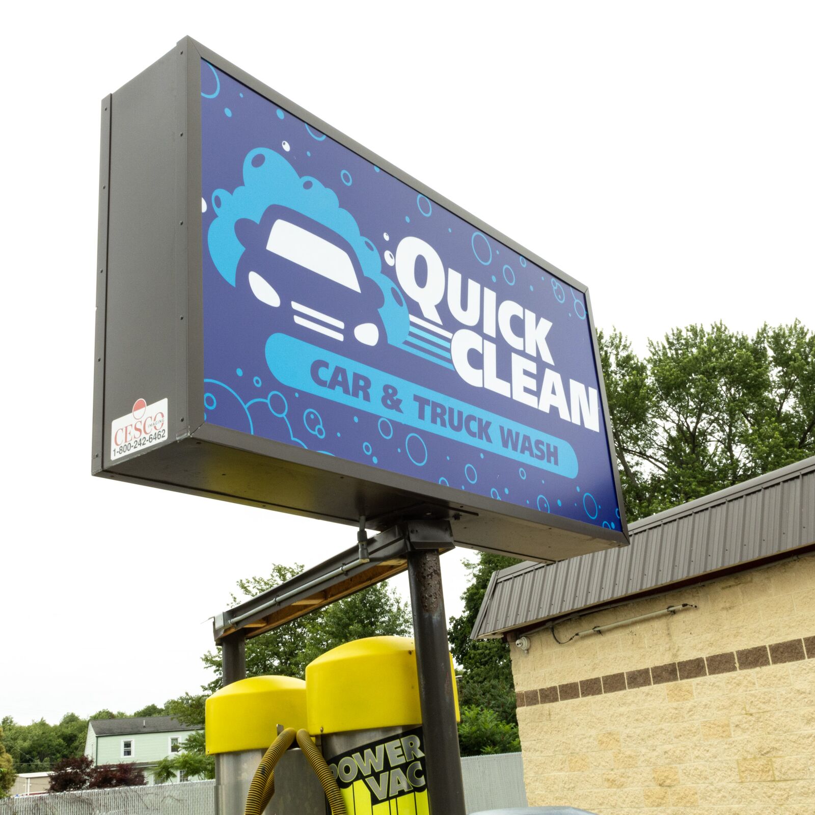 Close-up of the illuminated Quick Clean Car and Truck Wash sign