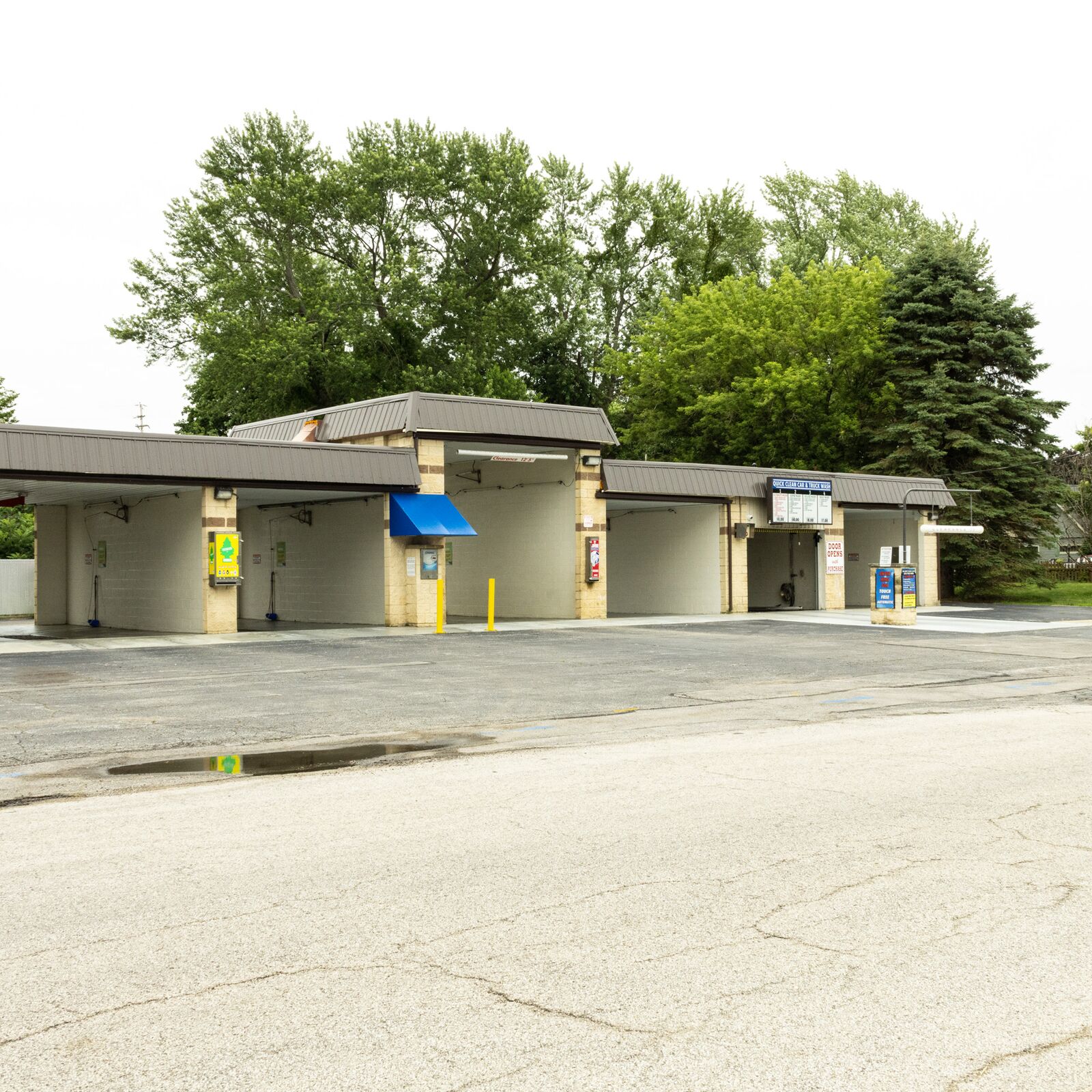 Wide exterior view of the wash bays and parking lot